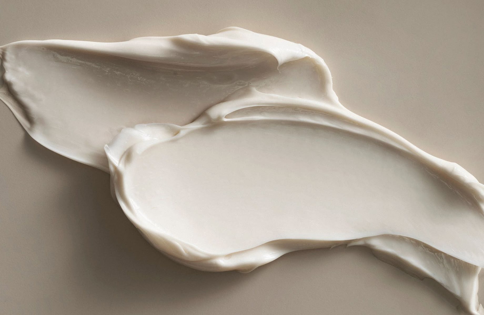 A nude cream emulsion spread on a nude background